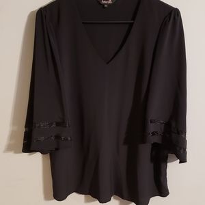 Amaryllis womens black top with 3/4 bell sleeves with sheer detail.